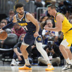 
              Denver Nuggets guard Jamal Murray, left, looks to pass the ball as Indiana Pacers guard T.J. McConnell defends in the first half of an NBA basketball game Friday, Jan. 20, 2023, in Denver. (AP Photo/David Zalubowski)
            