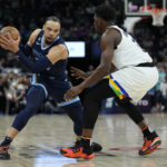 
              Memphis Grizzlies forward Dillon Brooks (24) handles the ball while defended by Minnesota Timberwolves guard Anthony Edwards (1) during the first half of an NBA basketball game, Friday, Jan. 27, 2023, in Minneapolis. (AP Photo/Abbie Parr)
            