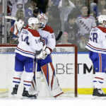 
              Montreal Canadiens goaltender Sam Montembeault (35) celebrates with Nick Suzuki (14) after defeating the New York Rangers in an NHL hockey game Sunday, Jan. 15, 2023, in New York. (AP Photo/Adam Hunger)
            