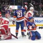 
              Detroit Red Wings goaltender Magnus Hellberg (45) reacts as New York Islanders' Anders Lee (27) celebrates after scoring a goal during the second period of an NHL hockey game Friday, Jan. 27, 2023, in Elmont, N.Y. (AP Photo/Frank Franklin II)
            