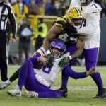 
              Minnesota Vikings quarterback Kirk Cousins (8) is sacked by Green Bay Packers linebacker Justin Hollins (47) during the first half of an NFL football game, Sunday, Jan. 1, 2023, in Green Bay, Wis. (AP Photo/Matt Ludtke)
            