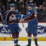 
              Colorado Avalanche defenseman Cale Makar, right, is congratulated after scoring a goal by defenseman Devon Toews in the second period of an NHL hockey game against the Detroit Red Wings, Monday, Jan. 16, 2023, in Denver. (AP Photo/David Zalubowski)
            
