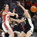 
              Ohio State guard Taylor Mikesell, left, passes in front of Purdue guard Cassidy Hardin during the first half of an NCAA college basketball game in Columbus, Ohio, Sunday, Jan. 29, 2023. (AP Photo/Paul Vernon)
            