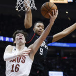 
              Cleveland Cavaliers forward Cedi Osman (16) shoots against Los Angeles Clippers center Moses Brown (9) during the second half of an NBA basketball game, Sunday, Jan. 29, 2023, in Cleveland. (AP Photo/Ron Schwane)
            