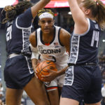 
              UConn's Aaliyah Edwards (3) is stopped by the defense of Georgetown's Ariel Jenkins (21) and Kristina Moore (14) in the first half of an NCAA college basketball game, Sunday, Jan. 15, 2023, in Hartford, Conn. (AP Photo/Jessica Hill)
            