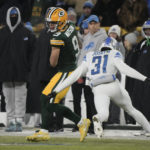 
              Green Bay Packers wide receiver Christian Watson (9) catches a pass as Detroit Lions safety Kerby Joseph (31) defends during the first half of an NFL football game Sunday, Jan. 8, 2023, in Green Bay, Wis. (AP Photo/Morry Gash)
            
