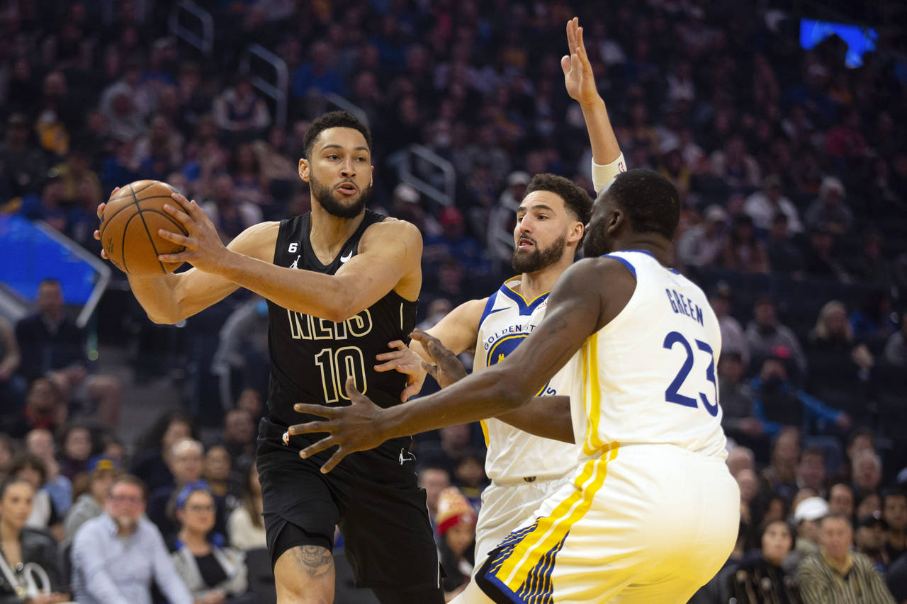 Brooklyn Nets guard Ben Simmons (10) looks to pass away from defensive pressure by Golden State War...