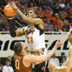 
              Oklahoma State forward Tyreek Smith (23) takes a shot over Texas forward Timmy Allen (0) while Texas forward Dylan Disu (1) watches during the first half of an NCAA college basketball game Saturday, Jan. 7, 2023, in Stillwater, Okla. Texas defeated Oklahoma State 56-46. (AP Photo/Brody Schmidt)
            
