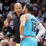 
              Phoenix Suns' head coach Monty Williams talks with Ish Wainwright (12) during the first half of an NBA basketball game against the Cleveland Cavaliers in Phoenix, Sunday, Jan. 8, 2023. (AP Photo/Darryl Webb)
            