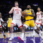 
              Los Angeles Lakers' LeBron James, front right, drives to the basket under pressure by Houston Rockets' Alperen Sengun (28) during the first half of an NBA basketball game Monday, Jan. 16, 2023, in Los Angeles. (AP Photo/Jae C. Hong)
            