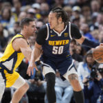 
              Denver Nuggets forward Aaron Gordon, right, is defended by Indiana Pacers guard T.J. McConnell during the first half of an NBA basketball game Friday, Jan. 20, 2023, in Denver. (AP Photo/David Zalubowski)
            