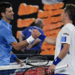 
              Novak Djokovic, left, of Serbia is congratulated by Roberto Carballes Baena of Spain following their first round match at the Australian Open tennis championship in Melbourne, Australia, Wednesday, Jan. 18, 2023. (AP Photo/Aaron Favila)
            