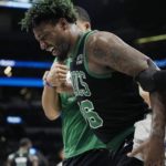 
              Boston Celtics guard Marcus Smart (36) is helped off the court following an injury during the second half of an NBA basketball game against the San Antonio Spurs in San Antonio, Saturday, Jan. 7, 2023. (AP Photo/Eric Gay)
            