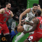 
              Boston Celtics forward Jayson Tatum (0) is surrounded by Chicago Bulls on a drive to the basket during the first half of an NBA basketball game, Monday, Jan. 9, 2023, in Boston. (AP Photo/Charles Krupa)
            