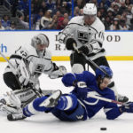 
              Tampa Bay Lightning center Anthony Cirelli (71) tries to play the puck after getting knocked down by Los Angeles Kings center Anze Kopitar (11) in front of goaltender Jonathan Quick (32) during the second period of an NHL hockey game Saturday, Jan. 28, 2023, in Tampa, Fla. (AP Photo/Chris O'Meara)
            