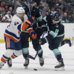 
              Seattle Kraken forward Ryan Donato, right, takes a shot on goal as forward Daniel Spring, center attempts to screen New York Islanders forward Jean-Gabriel Pageau during the second period of an NHL hockey game, Sunday, Jan. 1, 2023, in Seattle. (AP Photo/Stephen Brashear)
            