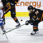 
              Colorado Avalanche forward Logan O'Connor, left, and Calgary Flames forward Elias Lindholm chase the puck during the third period of an NHL hockey game Wednesday, Jan. 18, 2023, in Calgary, Alberta. (Jeff McIntosh/The Canadian Press via AP)
            