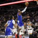 
              Los Angeles Clippers guard John Wall, top center, shoots over Minnesota Timberwolves guard D'Angelo Russell (0) with Clippers' Moses Brown and Timberwolves' Taurean Prince (12) watching in the second quarter of an NBA basketball game Friday, Jan. 6, 2023, in Minneapolis. (AP Photo/Andy Clayton-King)
            