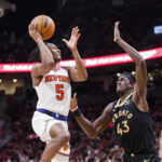 
              New York Knicks guard Immanuel Quickley (5) shoots over Toronto Raptors forward Pascal Siakam (43) during the second half of an NBA basketball game Friday, Jan. 6, 2023, in Toronto. (Cole Burston/The Canadian Press via AP)
            