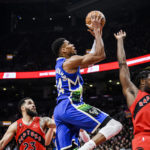 
              Milwaukee Bucks forward Giannis Antetokounmpo (34) lays up the ball as Toronto Raptors forward O.G. Anunoby (3) and guard Fred VanVleet (23) defend during the first half of an NBA basketball game in Toronto on Wednesday, Jan. 4, 2023. (Christopher Katsarov/The Canadian Press via AP)
            