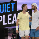 
              Karen Khachanov, right, of Russia gestures to Sebastian Korda of the U.S. after Korda withdrew from their match with an injured wrist during their quarterfinal match at the Australian Open tennis championship in Melbourne, Australia, Tuesday, Jan. 24, 2023. (AP Photo/Dita Alangkara)
            