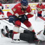 
              Florida Panthers defenseman Radko Gudas (7) collides with Arizona Coyotes center Laurent Dauphin (26) as they battle for the puck during the first period of an NHL hockey game, Tuesday, Jan. 3, 2023, in Sunrise, Fla. (AP Photo/Wilfredo Lee)
            