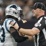 
              Umpire Mike Morgan pushes Carolina Panthers running back D'Onta Foreman back during the second half an NFL football game between the Carolina Panthers and the New Orleans Saints in New Orleans, Sunday, Jan. 8, 2023. (AP Photo/Gerald Herbert)
            
