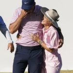 
              FILE - Scottie Scheffler, left, reacts as he gets a hug from his wife, Meredith, after winning the Dell Technologies Match Play Championship golf tournament March 27, 2022, in Austin, Texas. Scheffler says his wife has come to understand golf a little better in their nine years together. (AP Photo/Tony Gutierrez, File)
            