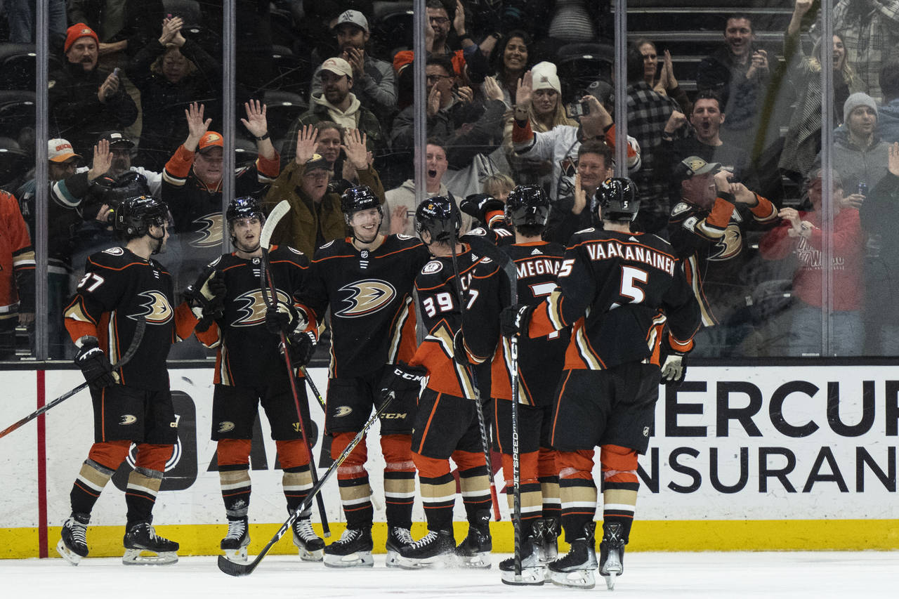 Anaheim Ducks celebrate a 5-4 overtime win over the San Jose Sharks in an NHL hockey game in Anahei...
