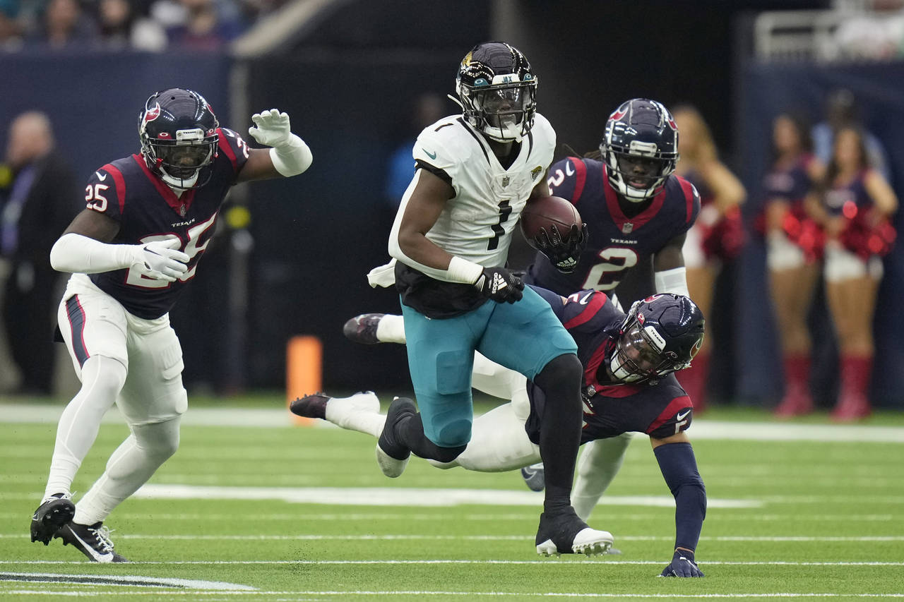 Jacksonville Jaguars running back Travis Etienne Jr. (1) runs for a touchdown against the Houston T...