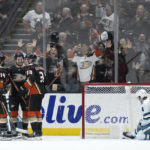 
              Anaheim Ducks center Mason McTavish, second from left, celebrates his goal with center Adam Henrique (14) and right wing Jakob Silfverberg (33) during the second period of the team's NHL hockey game against the San Jose Sharks in Anaheim, Calif., Friday, Jan. 6, 2023. (AP Photo/Kyusung Gong)
            