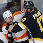 
              Philadelphia Flyers right wing Travis Konecny (11) and Bruins left wing Nick Foligno (17) fight along the boards during the second period of an NHL hockey game, Monday, Jan. 16, 2023, in Boston. (AP Photo/Mary Schwalm)
            