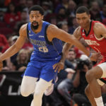 
              Dallas Mavericks' Spencer Dinwiddie (26) grabs the ball in front of Houston Rockets' Jabari Smith Jr. (1) during the first half of an NBA basketball game Monday, Jan. 2, 2023, in Houston. (AP Photo/David J. Phillip)
            