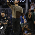 
              Golden State Warriors injured guard Stephen Curry celebrates during the second half of an NBA basketball game against the Atlanta Hawks in San Francisco, Monday, Jan. 2, 2023. (AP Photo/Jed Jacobsohn)
            