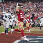 
              FILE - San Francisco 49ers running back Christian McCaffrey (23) celebrates after scoring a touchdown against the Seattle Seahawks during the first half of an NFL wild-card playoff football game in Santa Clara, Calif., Jan. 14, 2023. New York Giants running back Saquon Barkley, McCaffrey and Seattle Seahawks quarterback Geno Smith are the finalists for AP Comeback Player of the Year. (AP Photo/Godofredo A. Vásquez, File)
            