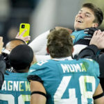 
              Jacksonville Jaguars place kicker Riley Patterson, top right, and his team celebrate his game-winning field goal against the Los Angeles Chargers during the second of an NFL wild-card football game, Saturday, Jan. 14, 2023, in Jacksonville, Fla. Jacksonville Jaguars won 31-30. (AP Photo/John Raoux)
            