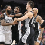 
              Brooklyn Nets' Markieff Morris, left, tangles with San Antonio Spurs' Stanley Johnson, Zach Collins and Jeremy Sochan, from left, during the first half of an NBA basketball game Tuesday, Jan. 17, 2023, in San Antonio. (AP Photo/Darren Abate)
            
