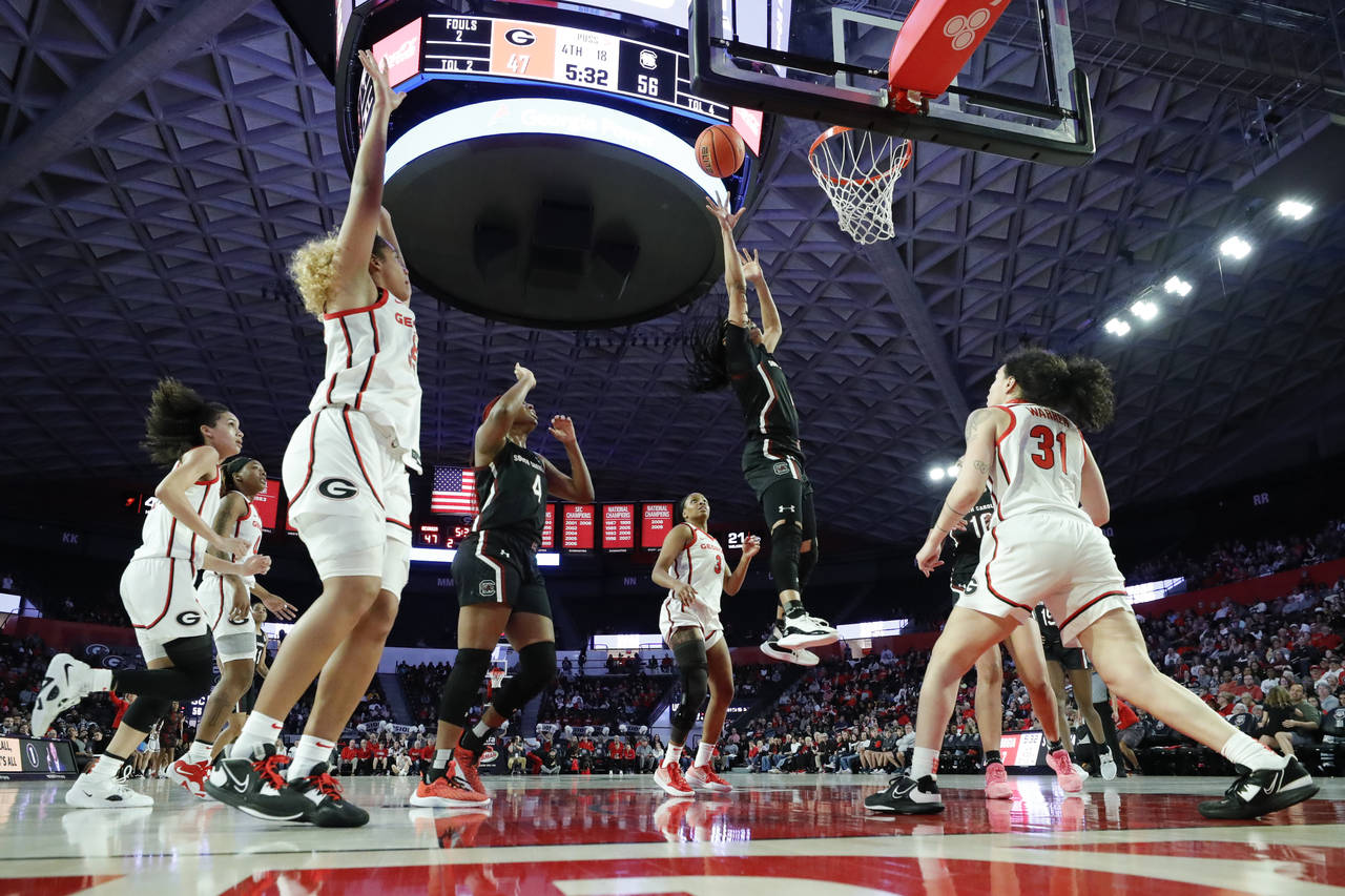 South Carolina guard Zia Cooke, second from right, shoots over Georgia guard Audrey Warren, right, ...