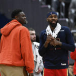
              Injured New Orleans Pelicans forward Zion Williamson, left, talks with forward Naji Marshall, second from right, during a timeout in the second half of an NBA basketball game against the Washington Wizards, Monday, Jan. 9, 2023, in Washington. (AP Photo/Terrance Williams)
            