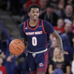 
              FILE - Detroit Mercy guard Antoine Davis brings the ball up during the second half of the team's NCAA college basketball game against Gonzaga in Spokane, Wash., Dec. 30, 2019. Davis, the nation's leading scorer, broke the Division I record for career 3-pointers with a spectacular shooting performance. He made a personal-best 11 3-pointers in a win over Robert Morris last Saturday, Jan. 14, 2023, giving him 513 in a career few saw coming when the 142-pound son of a coach stepped on campus at tiny Detroit Mercy. (AP Photo/Young Kwak, File)
            