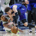 
              Boston Celtics guard Marcus Smart (36) and Charlotte Hornets guard LaMelo Ball (1) battle for a loose ball during the second half of an NBA basketball game on Saturday, Jan. 14, 2023, in Charlotte, N.C. (AP Photo/Scott Kinser)
            