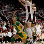 
              Stanford forward Cameron Brink, front right, blocks a shot by Oregon guard Endyia Rogers, left, during the first half of an NCAA college basketball game Sunday, Jan. 29, 2023, in Stanford, Calif. (AP Photo/Josie Lepe)
            