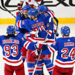 
              New York Rangers' K'Andre Miller (79) celebrates with Ben Harpur (5) and Chris Kreider (20) during the third period of an NHL hockey game against the Carolina Hurricanes Tuesday, Jan. 3, 2023, in New York. The Rangers won 5-3.(AP Photo/Frank Franklin II)
            
