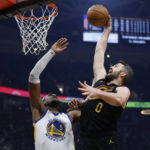 
              Cleveland Cavaliers forward Kevin Love (0) shoots against Golden State Warriors forward Kevon Looney (5) during the first half of an NBA basketball game Friday, Jan. 20, 2023, in Cleveland. (AP Photo/Ron Schwane)
            