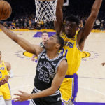 
              San Antonio Spurs guard Malaki Branham (22) shoots as Los Angeles Lakers center Thomas Bryant defends during the first half of an NBA basketball game Wednesday, Jan. 25, 2023, in Los Angeles. (AP Photo/Mark J. Terrill)
            