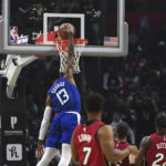 
              Los Angeles Clippers guard Paul George (13) slam dunks during the first half of an NBA basketball game against the Miami Heat, Monday, Jan. 2, 2023, in Los Angeles. (AP Photo/Allison Dinner)
            