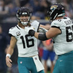 
              Jacksonville Jaguars quarterback Trevor Lawrence (16) and guard Brandon Scherff (68) celebrate a touchdown against the Houston Texans during the first half of an NFL football game in Houston, Sunday, Jan. 1, 2023. (AP Photo/David J. Phillip)
            