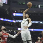 
              Milwaukee Bucks' Giannis Antetokounmpo dunks over New Orleans Pelicans' Jonas Valanciunas during the first half of an NBA basketball game Sunday, Jan. 29, 2023, in Milwaukee. (AP Photo/Morry Gash)
            