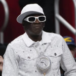 
              Entertainer Flavor Flav watches in the second half of an NBA basketball game between the Milwaukee Bucks and Detroit Pistons in Detroit, Monday, Jan. 23, 2023. (AP Photo/Paul Sancya)
            