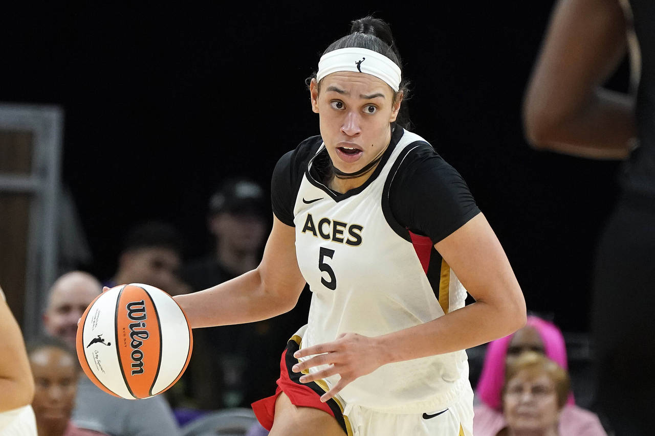 FILE - Las Vegas Aces' Dearica Hamby (5) dribbles up court during a WNBA basketball game against th...